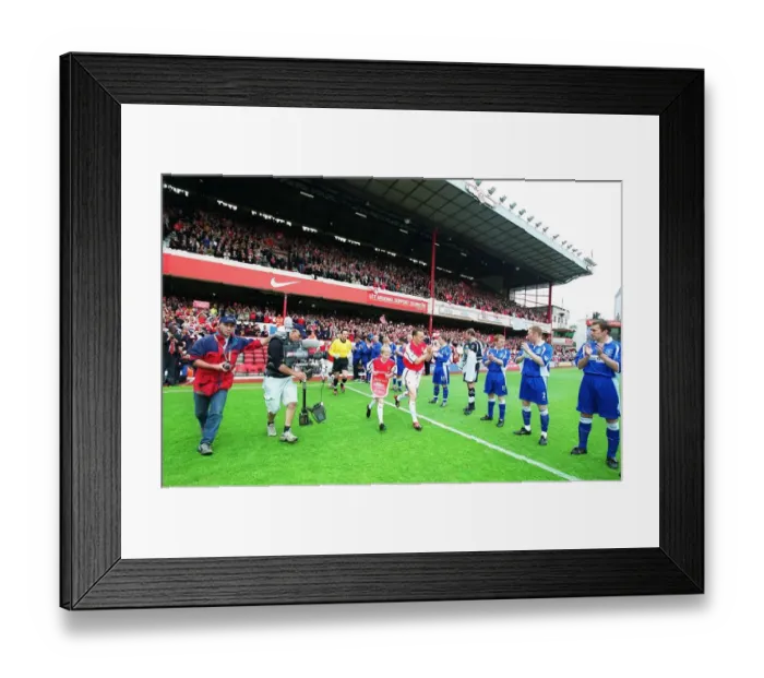 Framed Print : Arsenal captain Lee Dixon leads the team out onto the pitch for the match