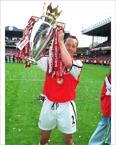 Lee Dixon (Arsenal) lifts the F. A. Barclaycard Premiership Trophy