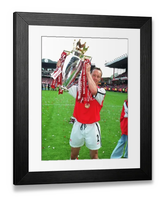 Framed Print : Lee Dixon (Arsenal) lifts the F. A. Barclaycard Premiership Trophy