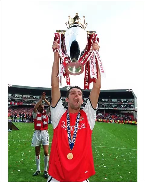 Edu (Arsenal) lifts the F. A. Barclaycard Premiership Trophy
