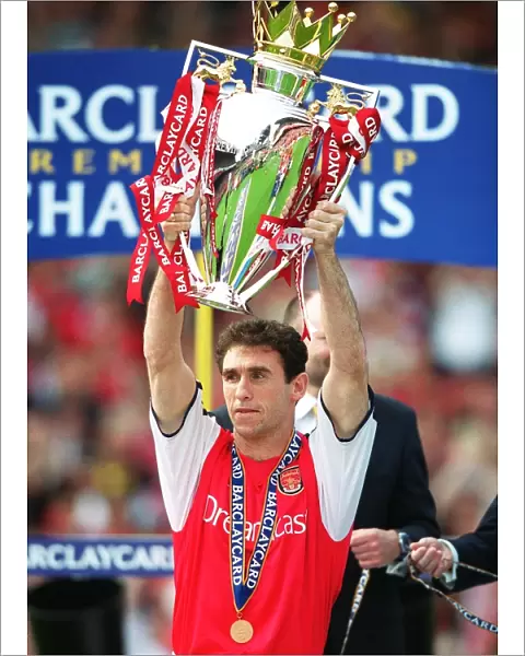 Martin Keown lifts the Premiership trophy after the match