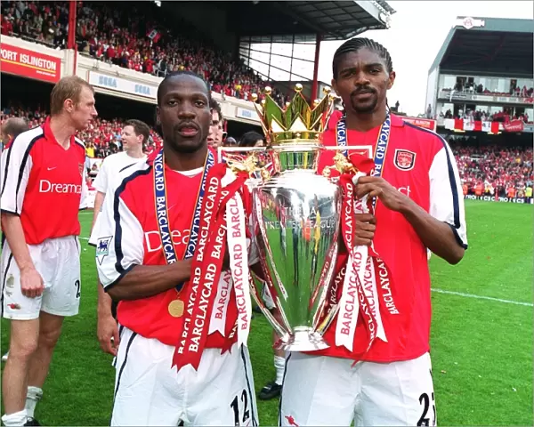 Lauren and Kanu lift the F. A. Barclaycard Premiership Trophy