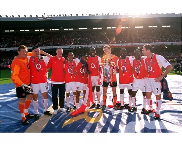 The Arsenal defenders and goalkeepers celebrate with the Premiership trophy