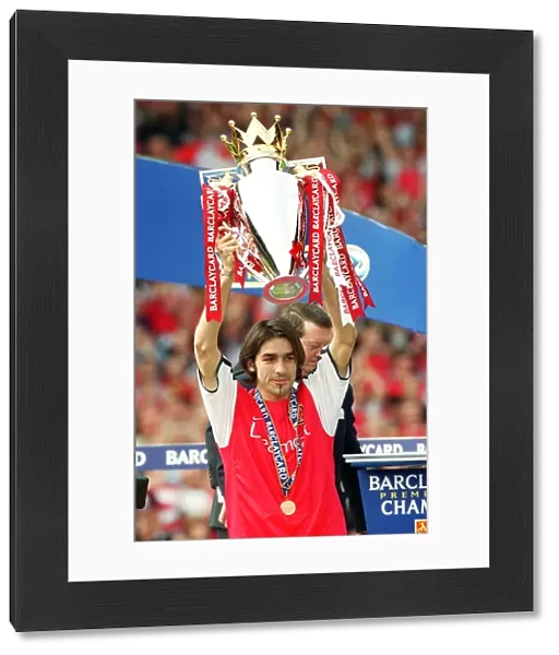 Robert Pires lifts the F. A. Barclaycard Premiership Trophy