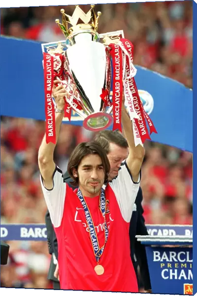 Robert Pires lifts the F. A. Barclaycard Premiership Trophy