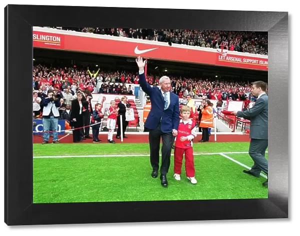 Arsenal goalkeeping coach Bob Wilson waves goodbye to the Arsenal fans