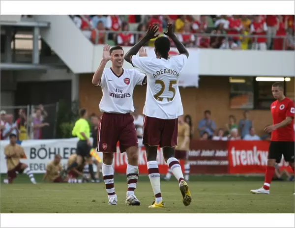 Robin van Persie celebrates scoring the 3rd Arsenal goal with Emmanuel Adebayor