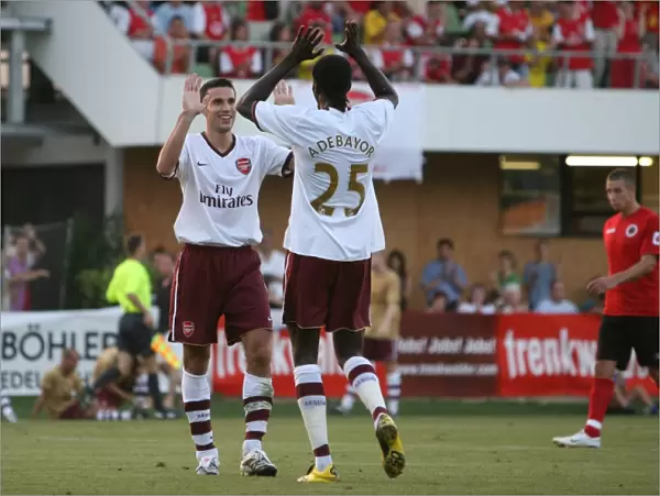 Robin van Persie celebrates scoring the 3rd Arsenal goal with Emmanuel Adebayor