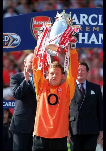 Graham Stack (Arsenal) lifts the Premiership Trophy. Arsenal v Leicester City