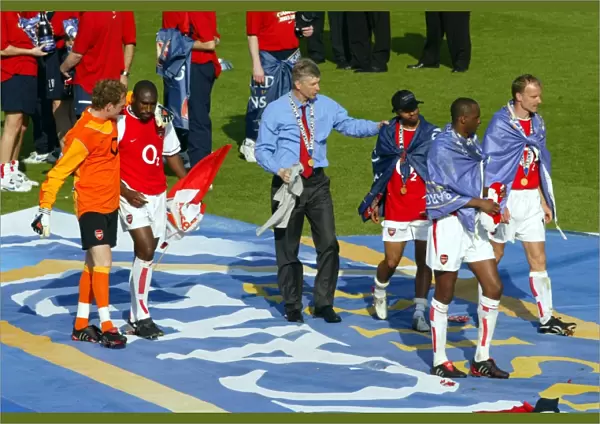 Arsene Wenger the Arsenal Managertalks to Ashley Cole at the end of the match