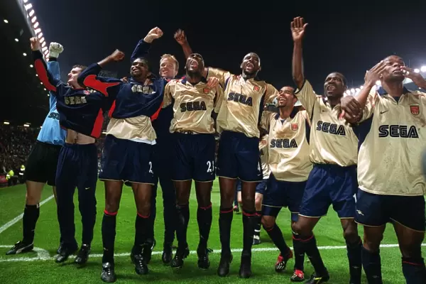 The Arsenal team celebrate the Championship victory after the match