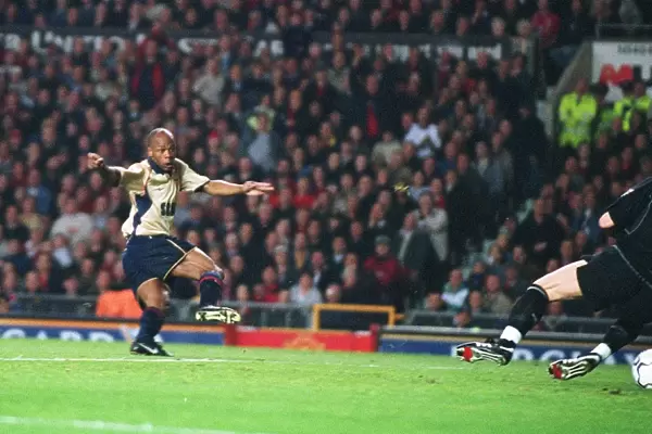 Sylvain Wiltord shoots past Manchester United goalkeeper Fabien Barthez to score the Arsenal goal th