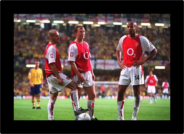 Freddie Ljungberg, ray Parlour and Thierry Henry (Arsenal) stand over the ball before taking a free