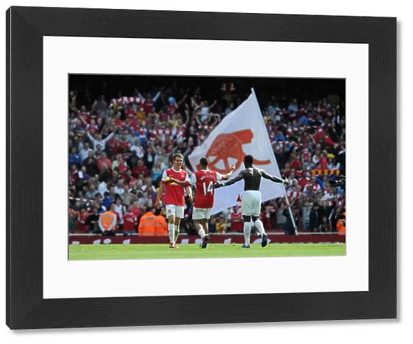 Aaron Ramsey, Theo Walcott and Emmanuel Eboue (Arsenal) celebrate at the end of the match