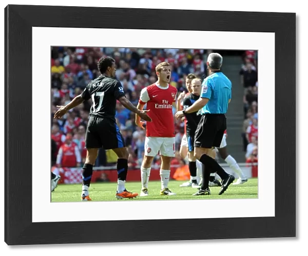 Jack Wilshere (Arsenal) and Nani (Man Utd) talk to Referee Chris Foy. Arsenal 1