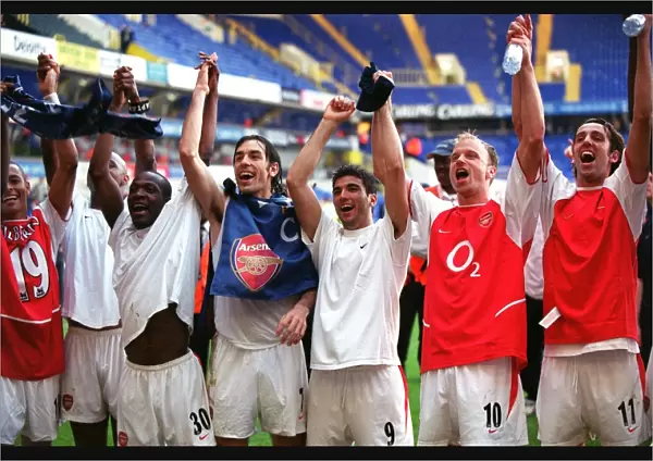 The Arsenal players celebrate Arsenal;s win in the photographers room (L>R) Gilberto