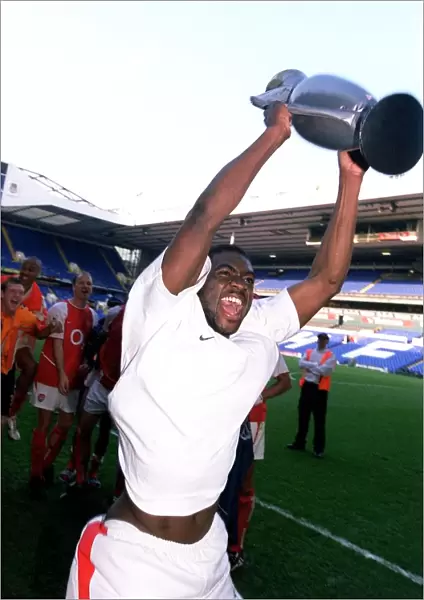 Arsenal's Kolo Toure Celebrates Premier League Victory with Inflatable Trophy at White Hart Lane
