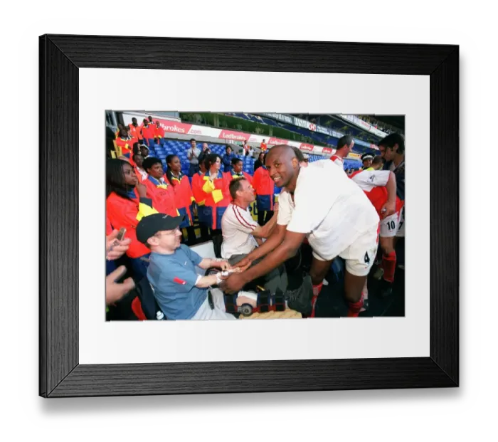 Framed Print : Patrick Vieira celebrates at the end of the match with a disabled fan Framed Print : Patrick Vieira celebrates at the end of the match with a disabled fan