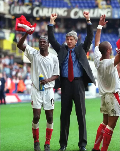 Arsene Wenger and Lauren celebrate at the end of the match