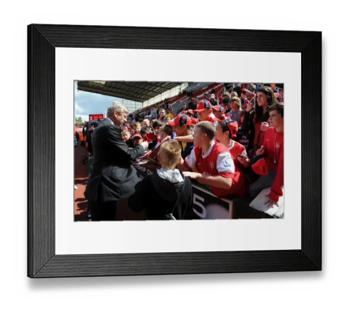 Framed Print : Arsenal manager Arsene Wenger signs autographs for the fans. Stoke City 3: 1 Arsenal