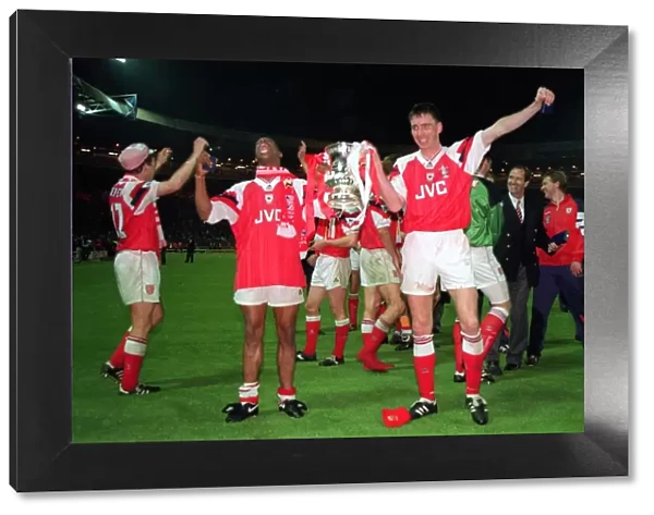 Ian Wright and Andy Linighan, the scorer of the winning goal, celebrate with the FA Cup Trophy after