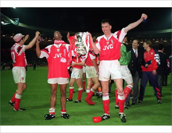 Ian Wright and Andy Linighan, the scorer of the winning goal, celebrate with the FA Cup Trophy after
