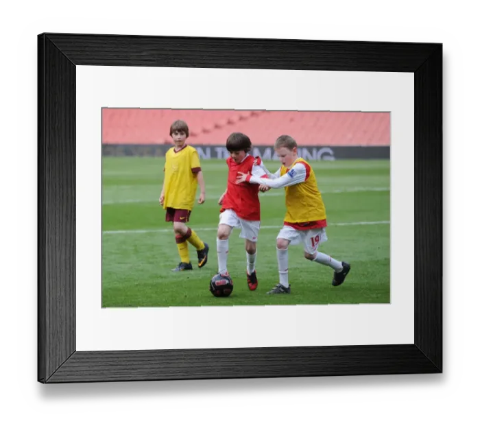 Framed Print : Young Gunners Struggle: Arsenal 1-2 Aston Villa (2011) - A Junior Gunner Fights On
