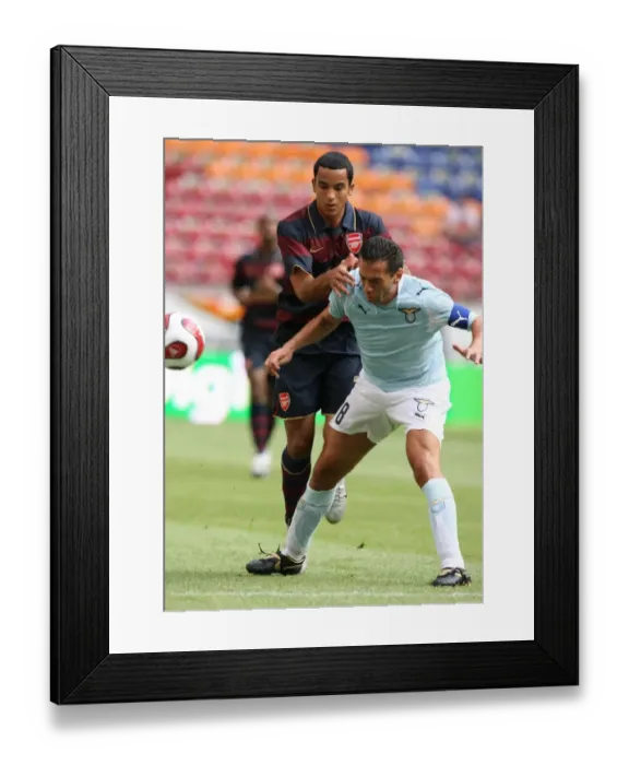 Framed Print : Theo Walcott (Arsenal) Luciano Zauri (Lazio)