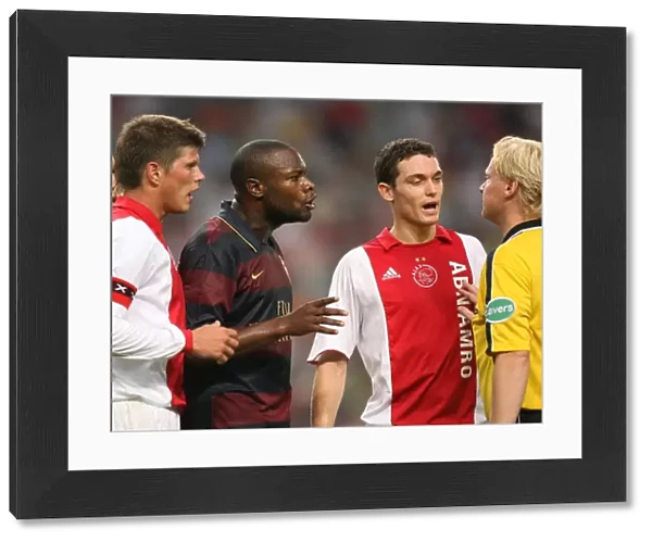 Arsenal captain William Gallas and Ajax defender Thomas Vermaelen talk to the referee
