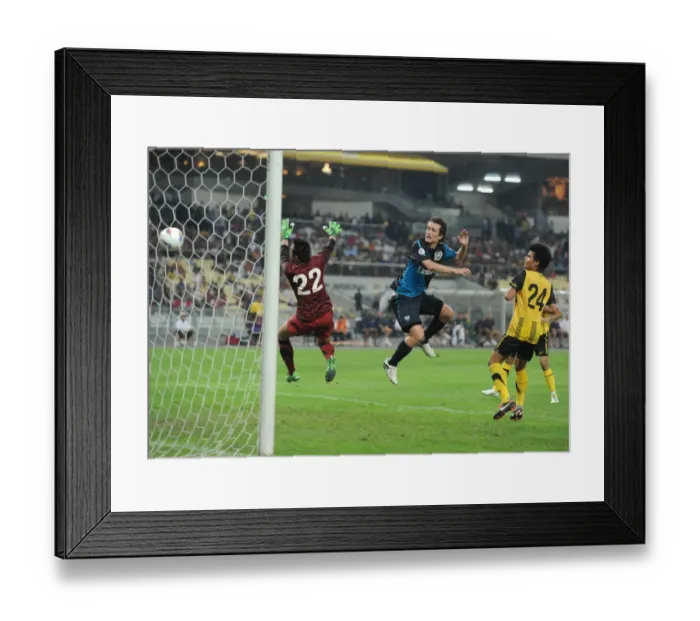 Framed Print : Tomas Rosicky heads past Malaysia goalkeeper Khairul Che Mat to score the 4th Arsenal goal Framed Print : Tomas Rosicky heads past Malaysia goalkeeper Khairul Che Mat to score the 4th Arsenal goal