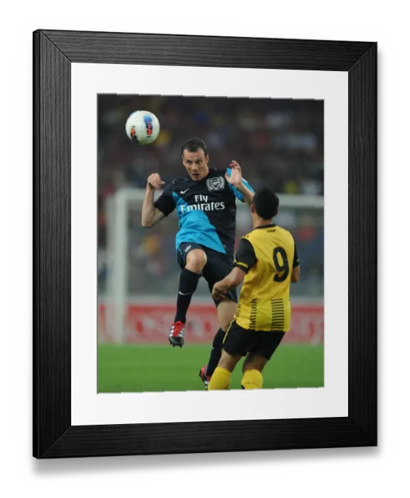 Framed Print : Sebastien Squillaci (Arsenal) Norshahrul Talaha (Malaysia). Malaysia XI 0: 4 Arsenal