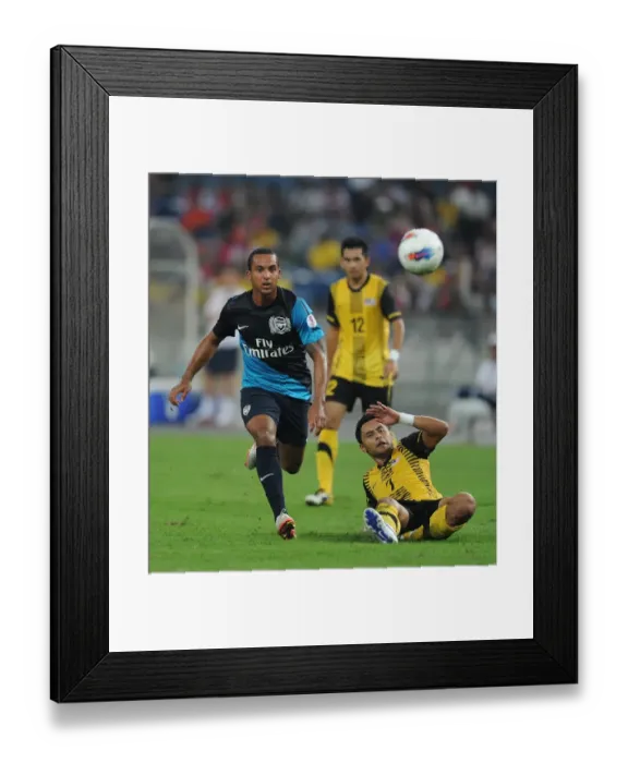 Framed Print : Theo Walcott (Arsenal) Mohd Zafuan (Malaysia). Malaysia XI 0: 4 Arsenal Framed Print : Theo Walcott (Arsenal) Mohd Zafuan (Malaysia). Malaysia XI 0: 4 Arsenal
