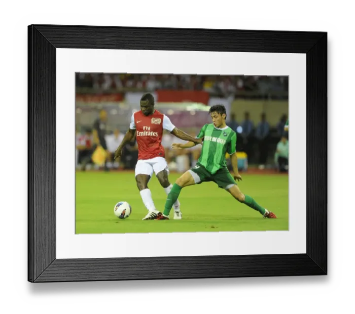 Framed Print : Emmanuel Frimpong vs. Tang Jiashu: Clash in the Far East (Hangzhou Greentown vs. Arsenal)