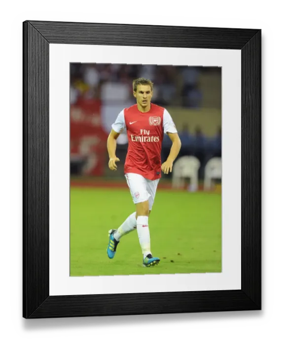 Framed Print : Arsenal Stars Face Off Against Hangzhou Greentown: A Look at Samir Nasri's Performance