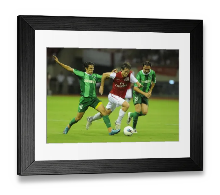 Framed Print : Arsenal's Tomas Rosicky Faces Off Against Hangzhou Greentown's Pezzolano and Vazquez Framed Print : Arsenal's Tomas Rosicky Faces Off Against Hangzhou Greentown's Pezzolano and Vazquez
