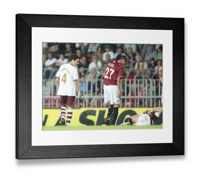 Framed Print : Cesc Fabregas (Arsenal) looks at injured Sparta Prague captain Tomas Repka