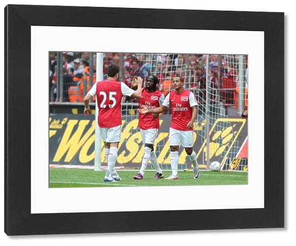 Gervinho, Jenkinson, and Walcott Celebrate Arsenal's Goals Against Cologne