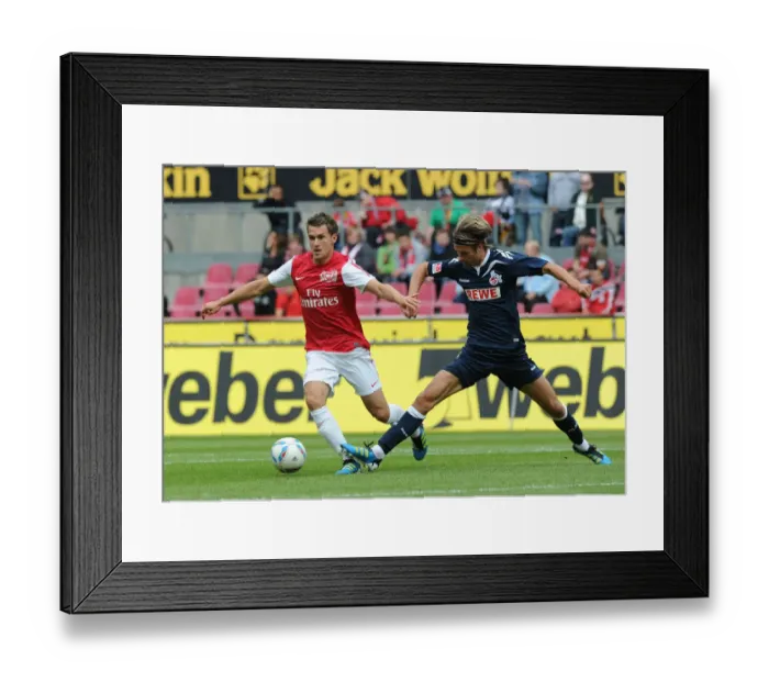Framed Print : Aaron Ramsey Faces Off Against Martin Lanig in Cologne Pre-Season Clash Framed Print : Aaron Ramsey Faces Off Against Martin Lanig in Cologne Pre-Season Clash