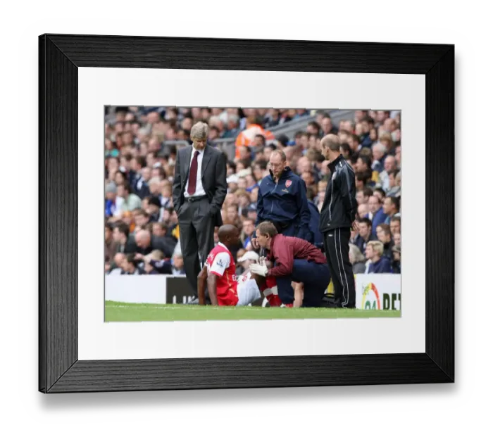 Framed Print : Arsenal manager Arsene Wenger looks on as injured captain William Gallas is treated by Gary Lewin Framed Print : Arsenal manager Arsene Wenger looks on as injured captain William Gallas is treated by Gary Lewin