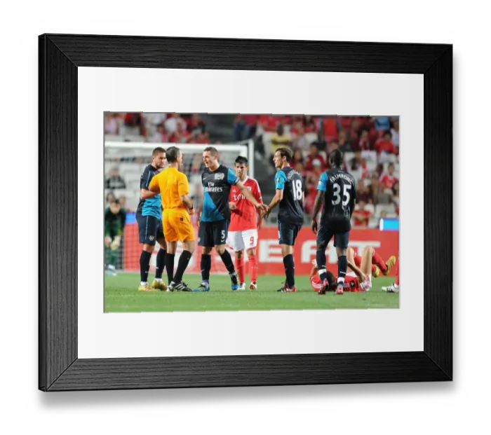Framed Print : Arsenal's Contentious Encounter with Benfica: Vermaelen, Squillaci, and Lansbury Clash with Referee Gomes Framed Print : Arsenal's Contentious Encounter with Benfica: Vermaelen, Squillaci, and Lansbury Clash with Referee Gomes