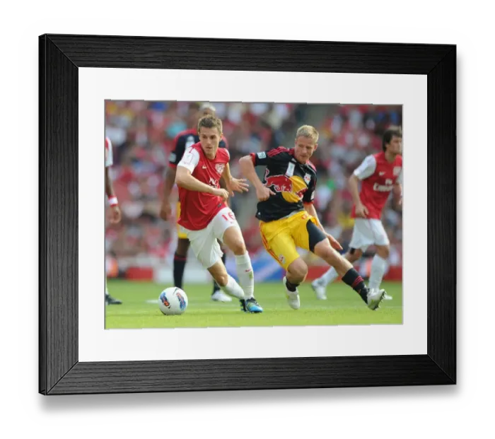 Framed Print : Arsenal's Aaron Ramsey Faces Off Against New York Red Bulls Dax McCarty during the 2011-12 Emirates Cup