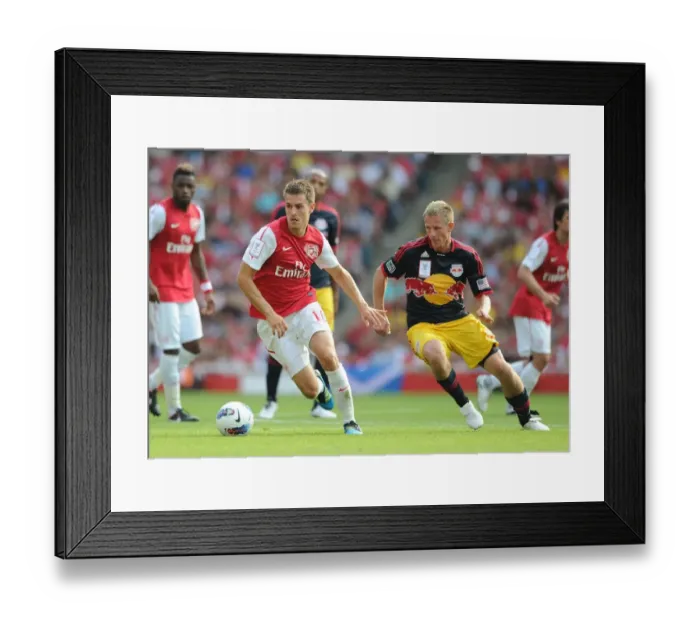 Framed Print : Clash of Midfield Maestros: Aaron Ramsey vs. Dax McCarthy during the Arsenal-New York Red Bulls 2011-12 Emirates Cup Face-Off