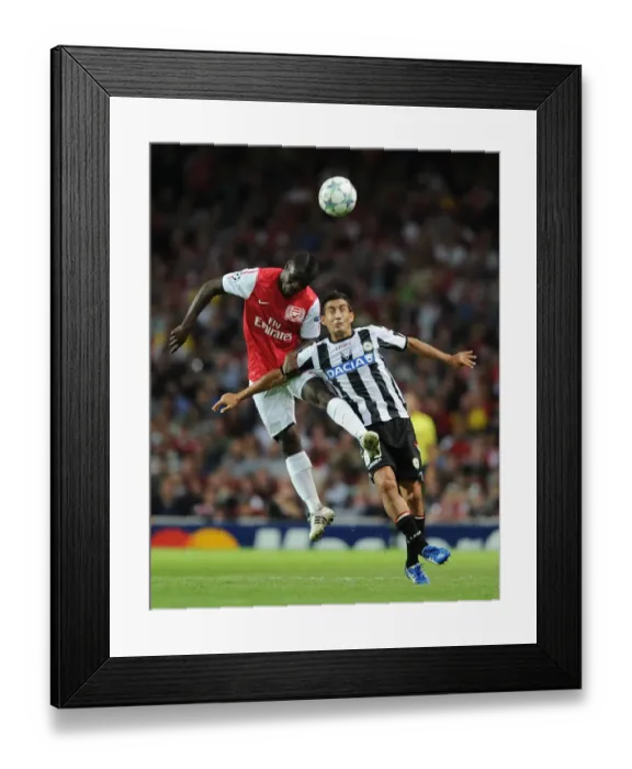 Framed Print : Arsenal vs Udinese: Emmanuel Frimpong Wins Headed Duel with Medhi Benatia in 2011-12 UEFA Champions League Play-Off