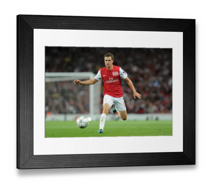 Framed Print : Arsenal's Aaron Ramsey in Action during the 2011-12 UEFA Champions League Play-Off against Udinese Framed Print : Arsenal's Aaron Ramsey in Action during the 2011-12 UEFA Champions League Play-Off against Udinese