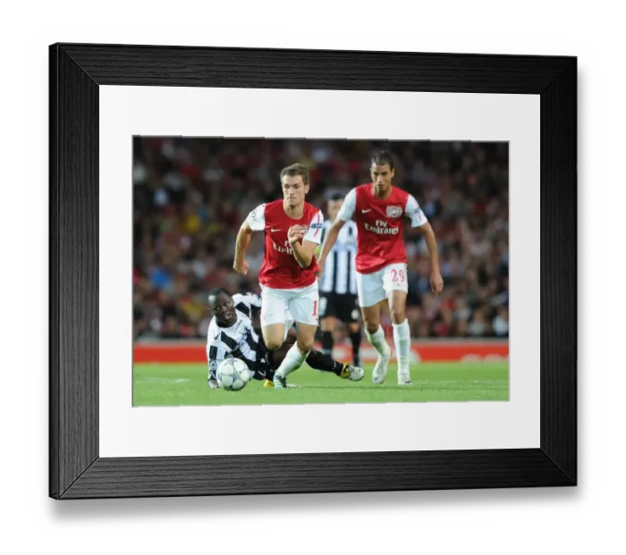 Framed Print : Arsenal's Aaron Ramsey Scores Past Udinese's Pablo Armero in 2011-12 UEFA Champions League Play-Off
