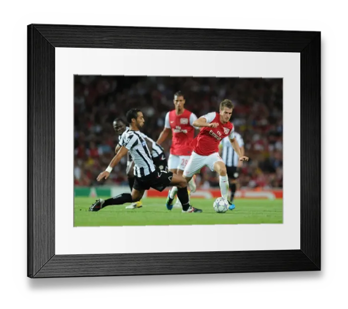 Framed Print : Arsenal's Aaron Ramsey vs. Medhi Benatia: Clash in the 2011 Champions League Play-Off Framed Print : Arsenal's Aaron Ramsey vs. Medhi Benatia: Clash in the 2011 Champions League Play-Off