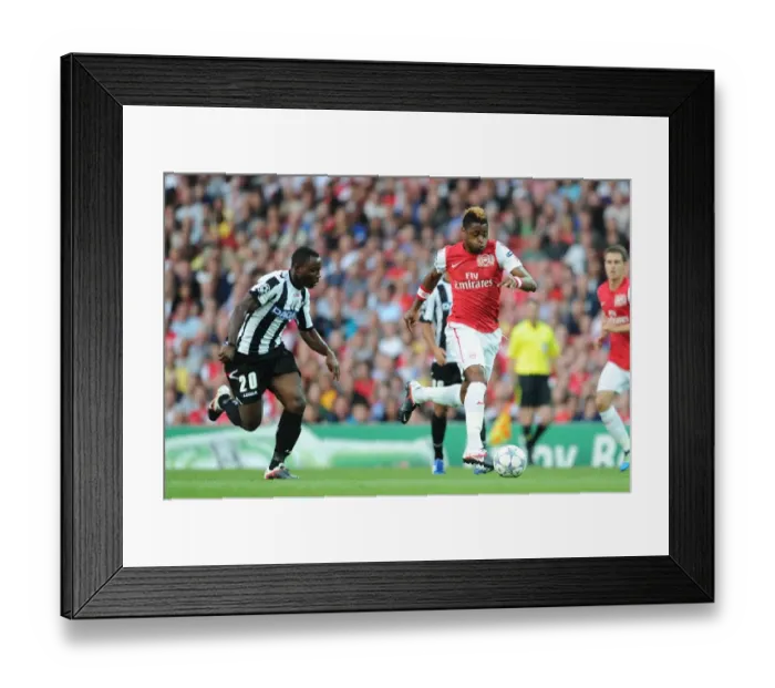 Framed Print : Arsenal's Alex Song Battles Past Udinese's Kwadwo Asamoah in 2011-12 Champions League Play-Off