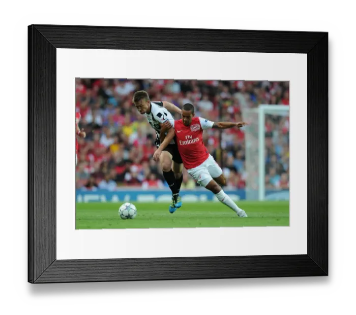 Framed Print : Theo Walcott vs Neuton: Arsenal's Battle in the UEFA Champions League Play-Off Against Udinese (2011) Framed Print : Theo Walcott vs Neuton: Arsenal's Battle in the UEFA Champions League Play-Off Against Udinese (2011)