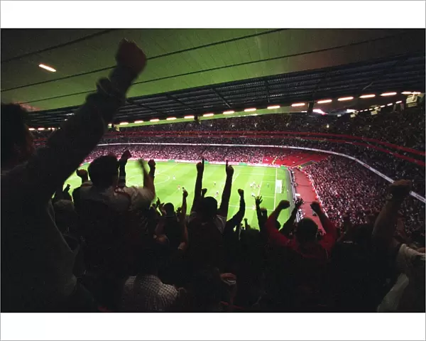 Emirates Stadium with fans cheering a goal