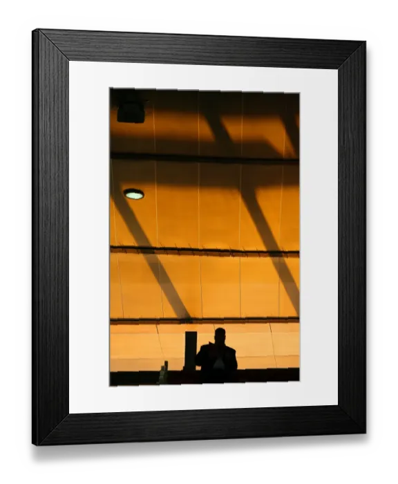 Framed Print : A fan reads his programme in the stadium